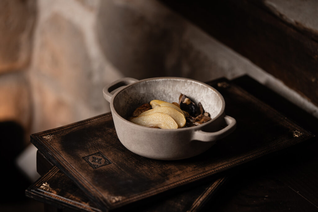 Signature dish served in a cast-iron pot, part of the Acrotel culinary experience